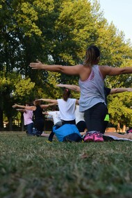 A group of people practicing yoga outdoors