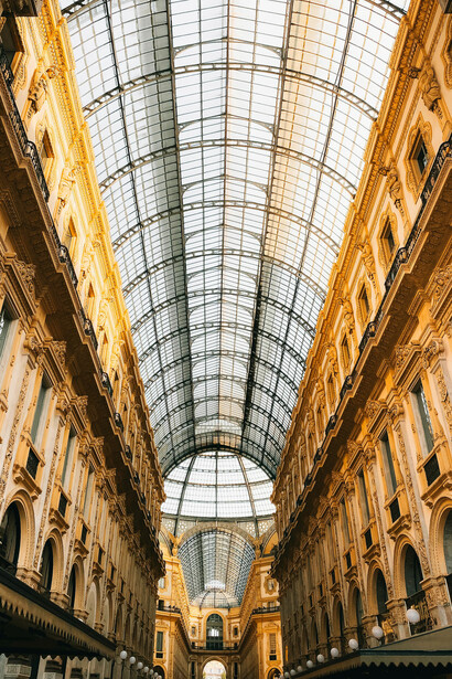 Interior view of Galleria Vittorio Emanuele II in Milan, Italy, featuring designer stores and glass-domed architecture