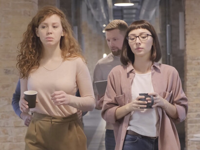 As colleagues walk and chat, they exemplify the power of positive relationships in driving success and well-being