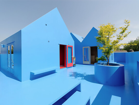 Didden Village in Rotterdam, Netherlands, uses vivid blue forms to create a symbolic rooftop landscape that blends architecture with imagination