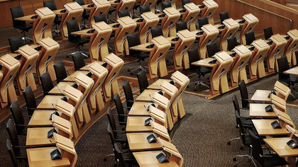The desks inside of the parliament building symbolize the heart of democracy, where crucial decisions are made to shape the future of society