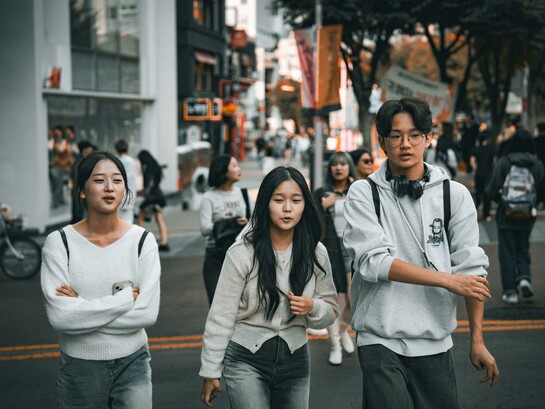 Young Korean students walking on the street while studying abroad