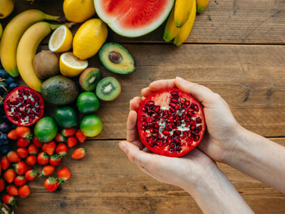 Overhead view of a person holding a fresh pomegranate
