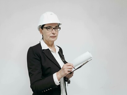 An architect with digital blueprints and 3D modeling empower her to visualize structures in precision 