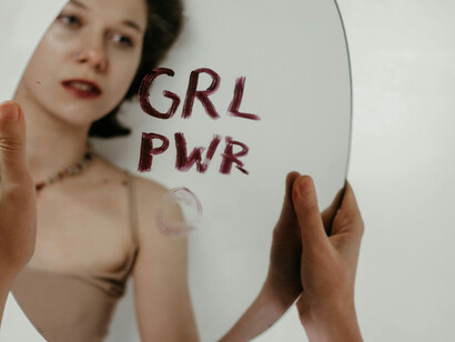 A mirror offers the reflection of a girl