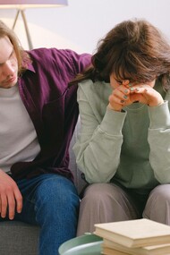 A man trying to console his friend who is dealing with a delicate and difficult situation