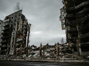 A shattered residential building looms under a heavy gray sky, a stark reminder of the Russia–Ukraine war, Ukraine