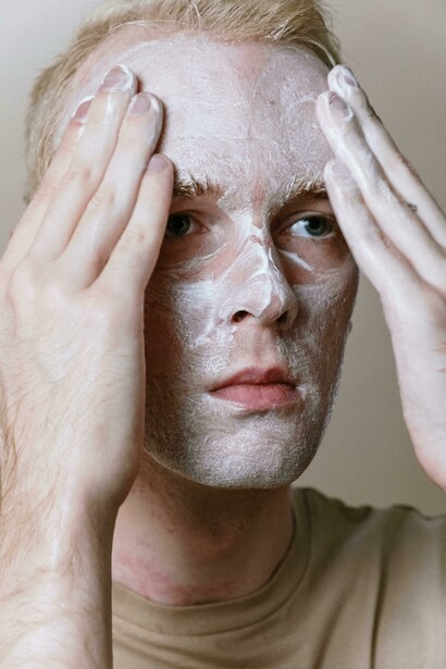 Man applying beauty creams and serums as part of his autumn skincare routine