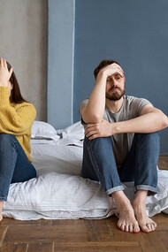 A couple experiencing communication difficulties, sitting on the floor