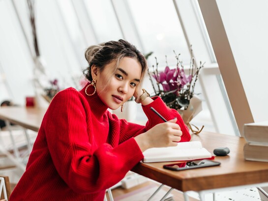 A woman writing in her diary, representing the quiet rebellion of self-expression