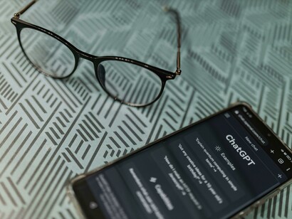 A phone with the page for ChatGPT open, highlighting AI’s growing role in daily tasks