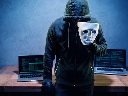 A hacker working at a desk, engaging in cybersecurity activities, navigating the digital battlefield, and potentially exploiting AI breaches to compromise data security in the context of cyber warfare