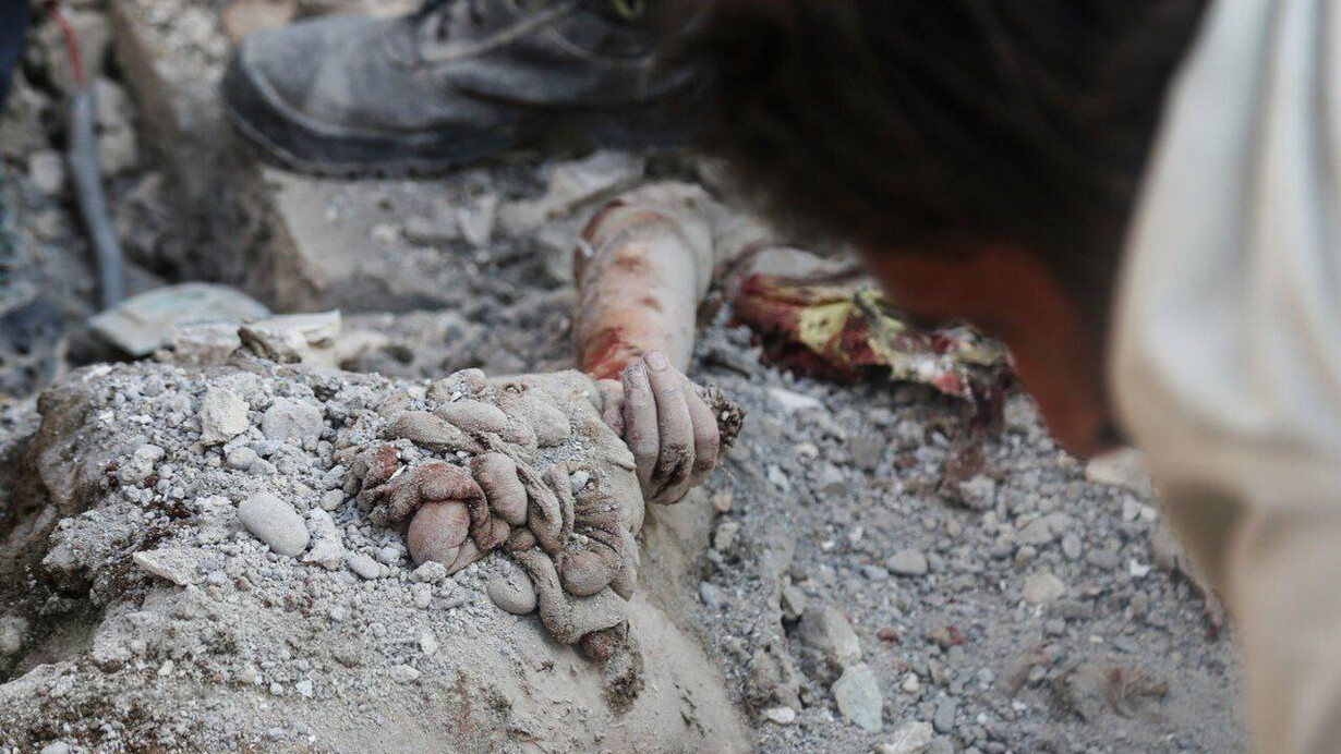 El cuerpo de una niña atrapado bajo los escombros de la escuela primaria Shajare Tayebé. De acuerdo con la ONU y varias organizaciones defensoras de los derechos humanos el ataque estadounidense contra la escuela fue un crimen de guerra