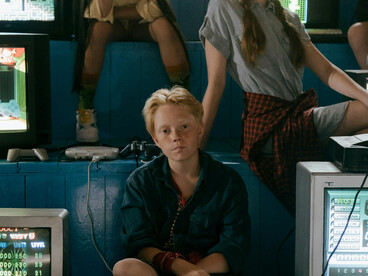 A group of teenagers playing retro video games on a TV, immersed in a nostalgic gaming atmosphere