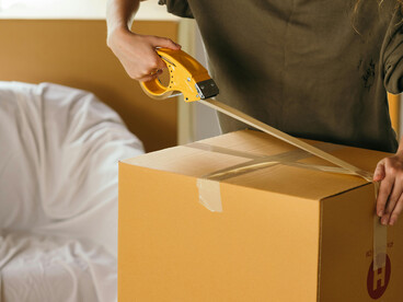 A woman packing up her bedroom, getting ready to move and start a new chapter in life