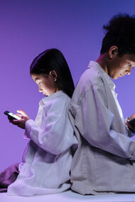 Lost in their phones, these young minds reflect the growing addiction to social media that fuels anxiety and distracts from meaningful experiences