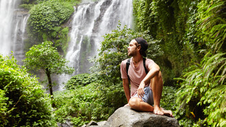 Surrounded by nature, he practices mindfulness, focusing on the present moment to clear his mind and reduce stress