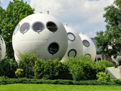 Located in the Dutch city of ’s-Hertogenbosch, Bolwoningen consists of 50 round houses clustered together in the suburban Maaspoort area