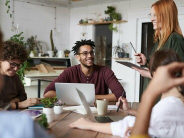 A team of young adults exchanging ideas, echoing the article’s theme of youth-driven problem-solving