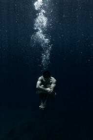 Man sitting underwater 