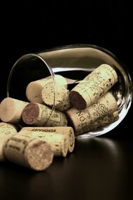 Brown wine corks gathered inside a clear glass
