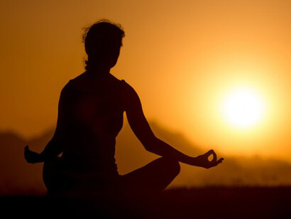 Yoga practice in the mountains at sunset, symbolizing spiritual connection, harmony between heart and mind, mindfulness, intuition, and the flow of invisible energy waves