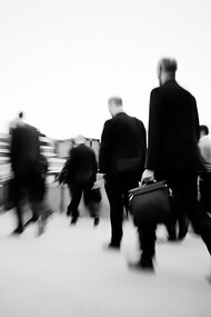 Morning commuters in London rush through the crowded streets, starting their workday