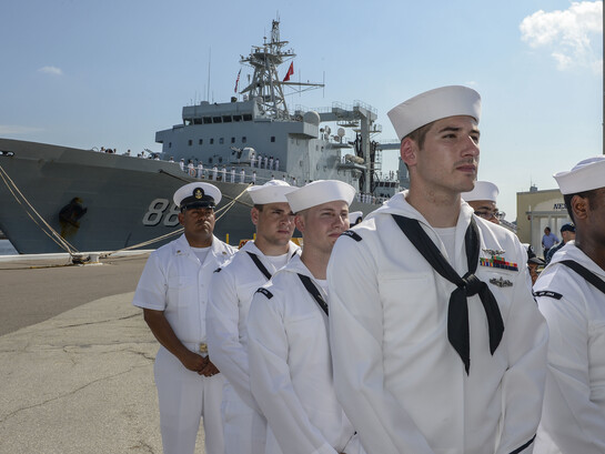 Sailors from the USS Iwo Jima (LHD 7) attend a ceremony commemorating the arrival of three ships from China's People's Liberation Army-Navy [PLA(N)] at Naval Station Mayport as part of a routine goodwill port visit