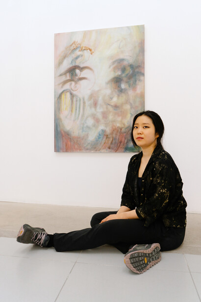 Naeun Kang captured in front of her work With your 
face this close (2), 2024. Courtesy of Nevven Gallery. Photography by Sara Lorusso