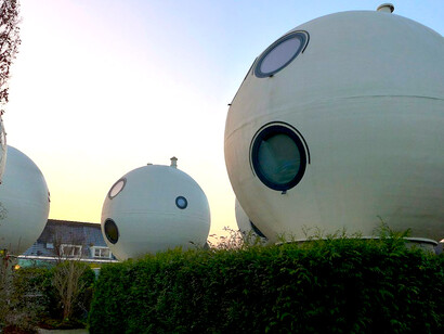 Bolwoningen are Dutch spherical houses in the Maaspoort neighborhood of 's-Hertogenbosch, Netherlands. It consists of 50 spherical houses grouped together near to a canal
