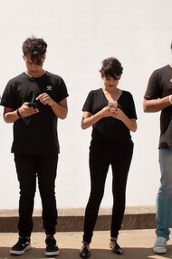 A gathering of individuals engrossed in their mobile phones