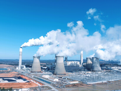 Power plant in Jiujiang, Jiangxi, China, with large smokestacks emitting smoke, representing the country’s industrial growth and environmental pressures