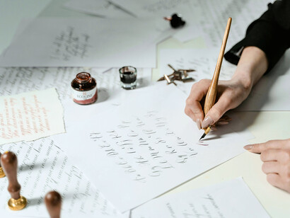 A hand tracing thoughts onto paper, representing the patient rebuilding of creative confidence