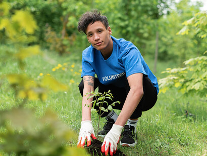 A man nurturing a seedling in his hands, embodying hope and responsibility for the environment