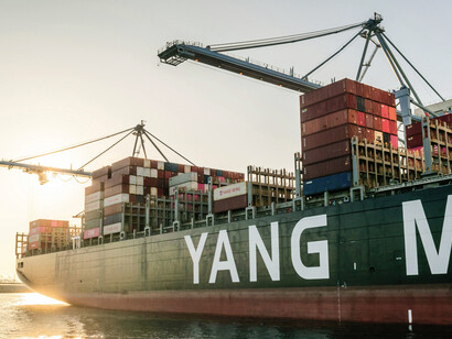View of a container ship in port, symbolizing the trade war, the rise of a multipolar world, and the decline of global hegemony