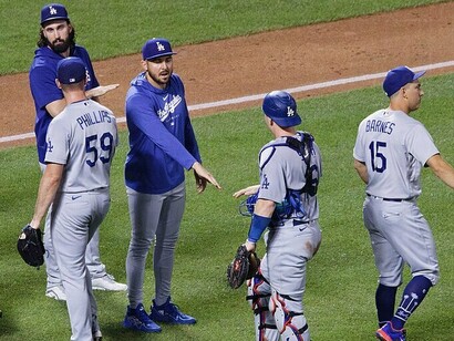 Los Angeles Dodgers players celebrate after winning a game, representing the fruit of their hard work and dedication throughout the season