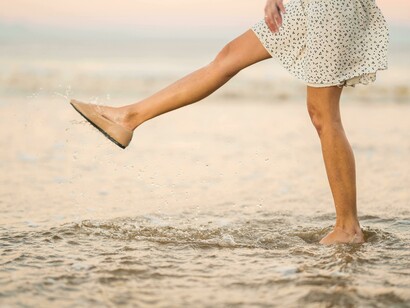 A women’s leg mid step in water displaying life’s movement 