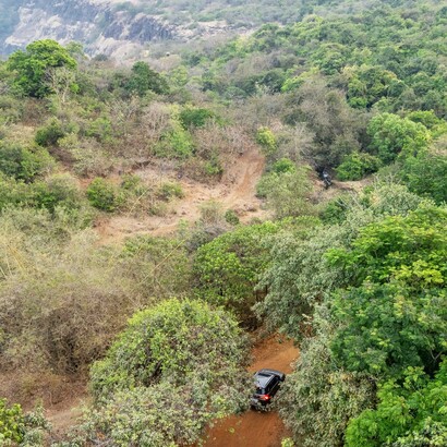 A brown Maruti Brezza explores the dirt roads of the Khandala Countryside, Lonavala, India; Lonavala is nestled among the Sahyadri hills in the western ghats of India


