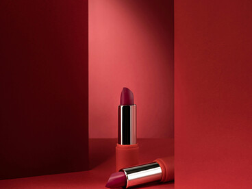 Elegant lipstick showcased on a striking red backdrop