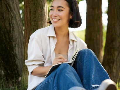 Journaling outside allows one to connect with their thoughts and feelings while drawing comfort from the surrounding environment