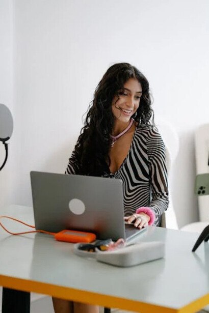 A young woman at her desk, using professional recording gear to produce content for her social media followers