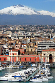Catania, a city black for the lava stone, white for the limestone of architectural decorations, and blue for its serene skies and the Ionian sea