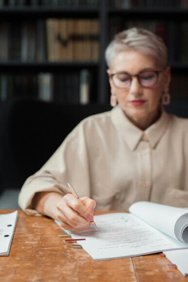 An editor carefully reviewing a manuscript