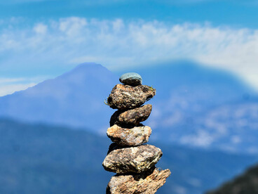 Cairn of stones with a panoramic Himalayan view