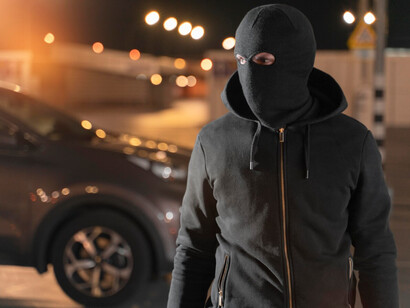 A masked character in an urban setting, visual code for Russian gangsters