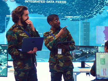 A group of military personnel analysing data feeds, reflecting the growing role of information systems in strategic planning