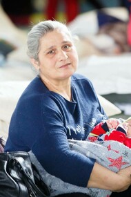 Ukrainian refugee Nagir holds her granddaughter at a refugee center, Moldova. UNFPA Moldova, Eduard Bîzgu, 4 March 2022