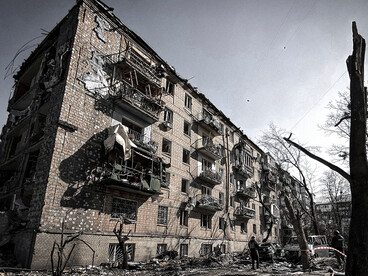 A ruined residential building stands beneath a gray sky amid the Russia–Ukraine war, Ukraine