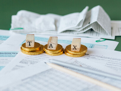 A table with tax documents and a few coins placed on it