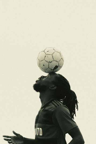 Athlete demonstrating focus while balancing a soccer ball